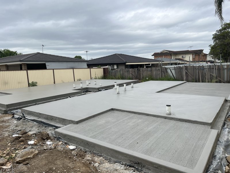 Finished house slab with step-downs and penetrations, ready for the builder