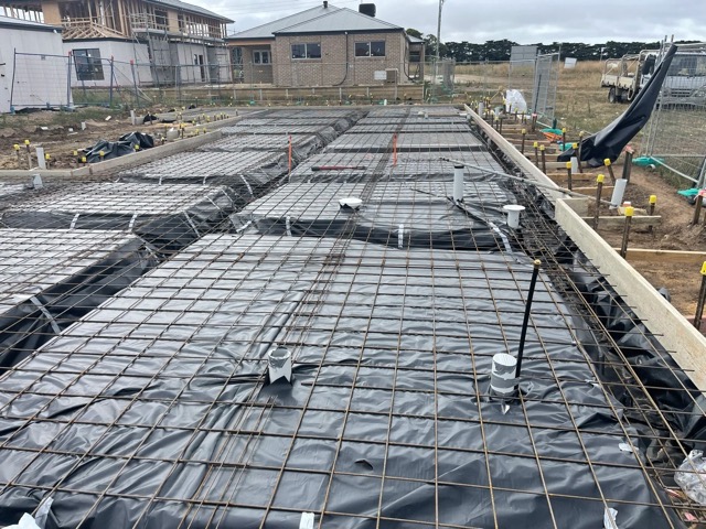 Reinforcement mesh and plastic membrane laid out before a slab pour